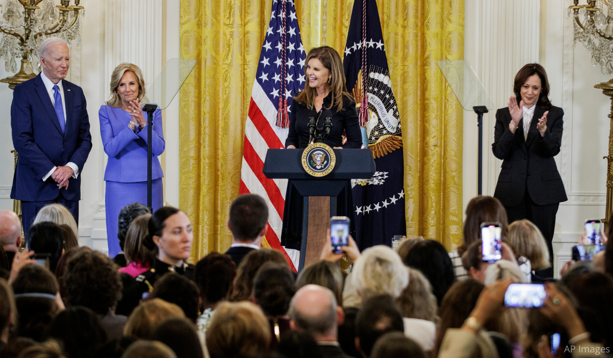 President Joe Biden, First Lady Jill Biden, and Vice President Kamala Harris listen as Maria gives a speech.