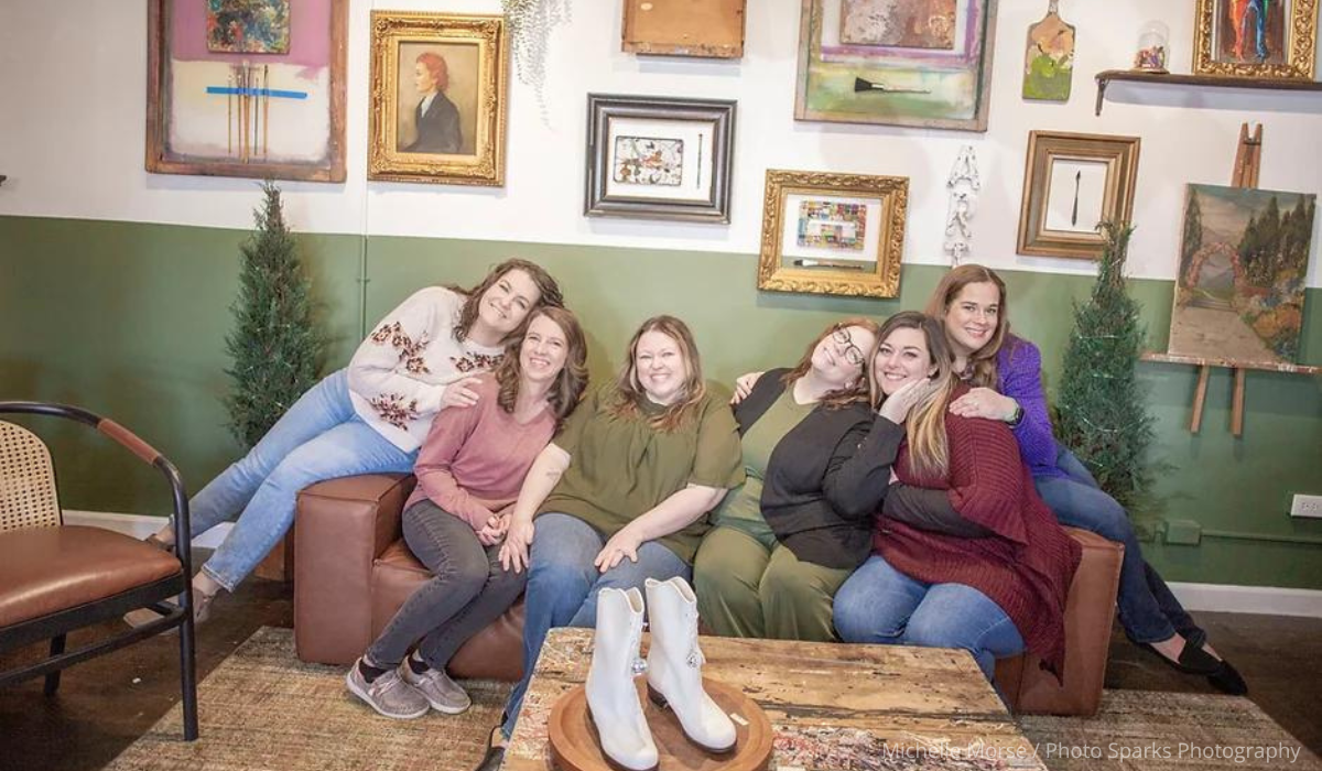 The women of Hot Mess Express Organization pose for a picture on a couch