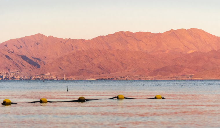 Sunset over the Red sea with pink orange mountains on the background.