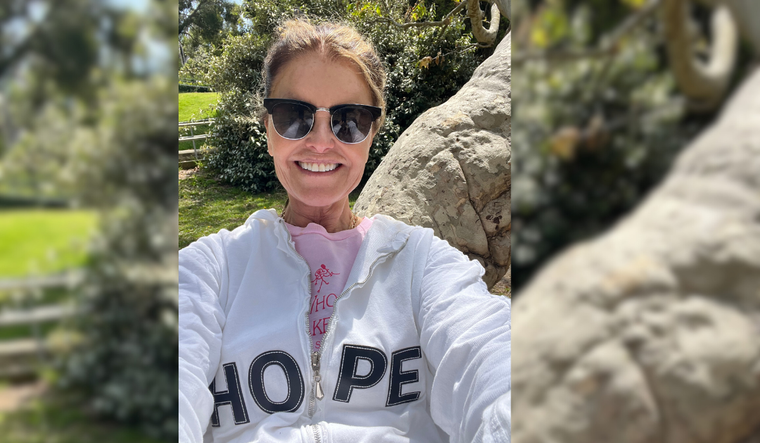 Maria takes a selfie wearing a shirt that says "Hope."