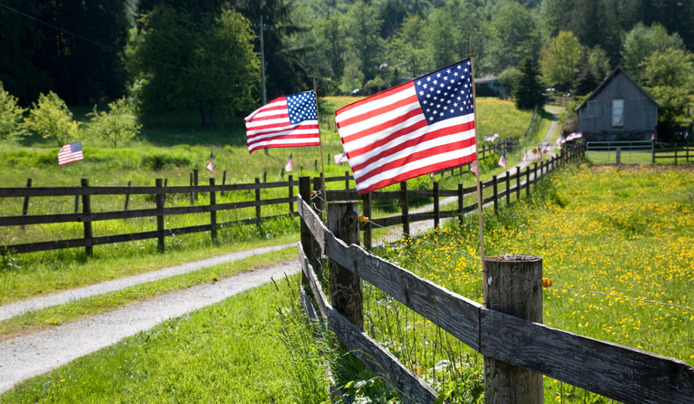 American flags on a fence post.