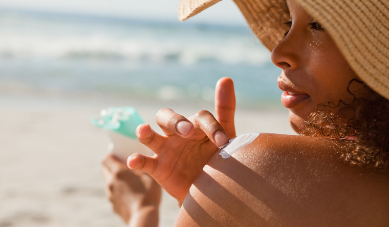 Woman applying sunscreen.