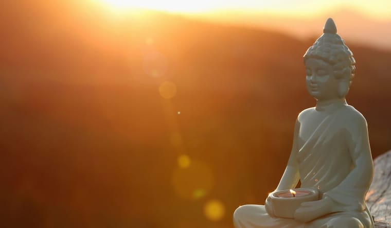 statue meditating under the sun.